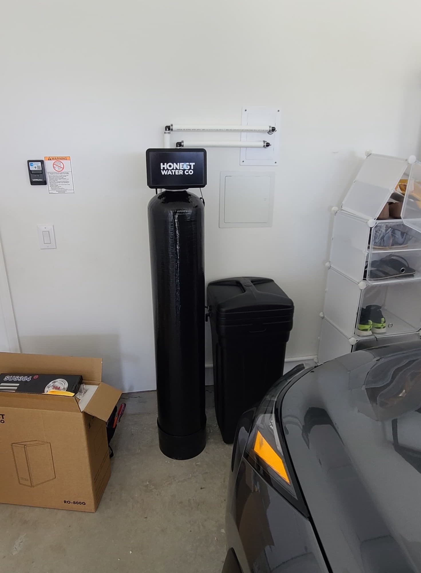 Honest Water Co system installed in a garage alongside the homeowner's car